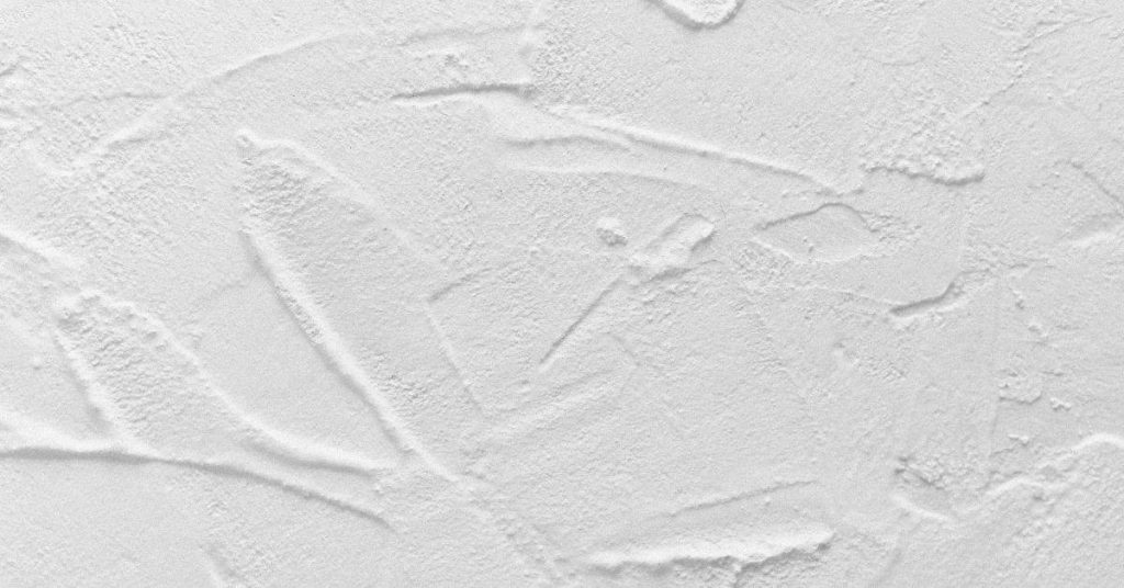 Close-up of white textured plaster wall surface