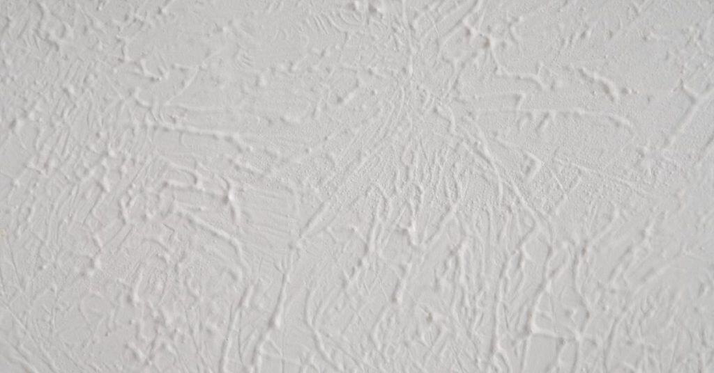 Close-up of white textured plaster wall surface