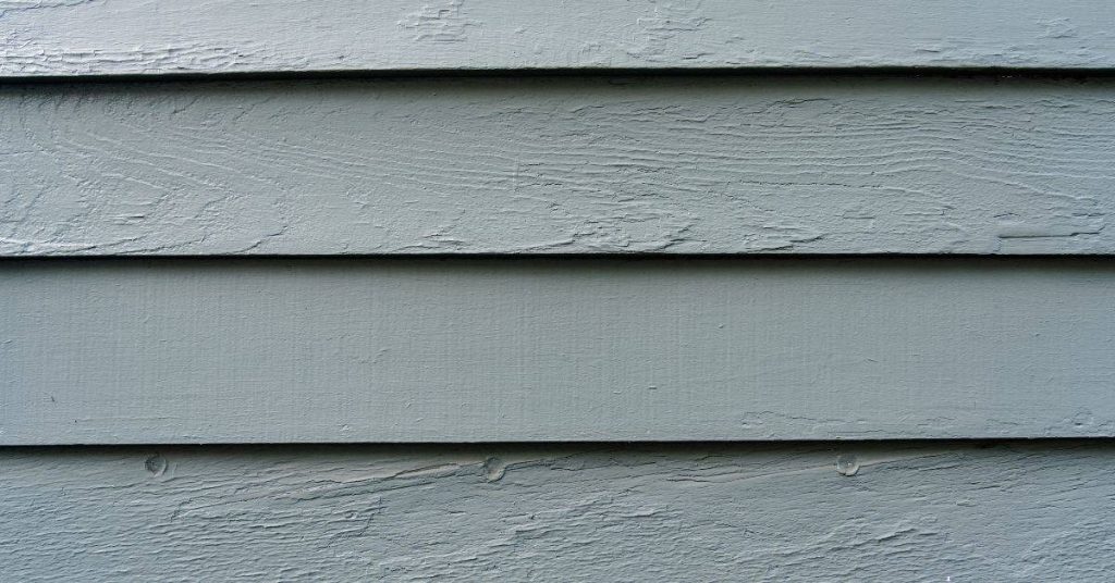 Closeup of painted wooden siding in gray color