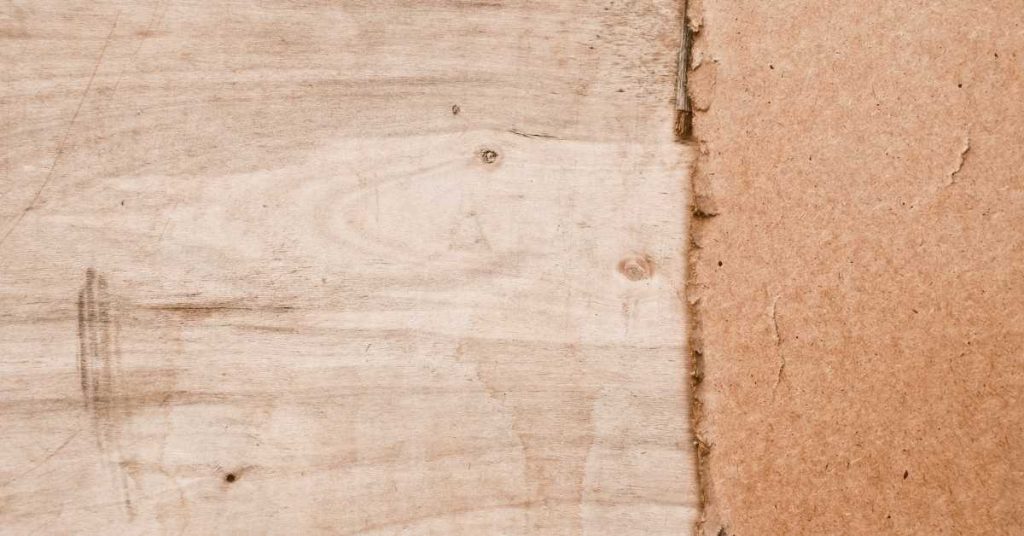 Closeup of rough plywood and fiberboard surfaces meeting