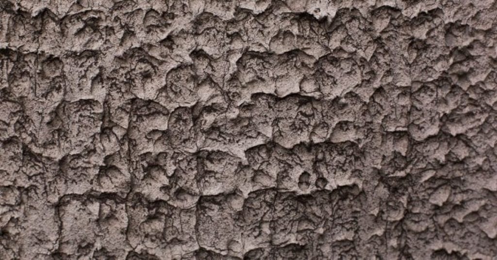 Closeup of rough textured brown stucco surface