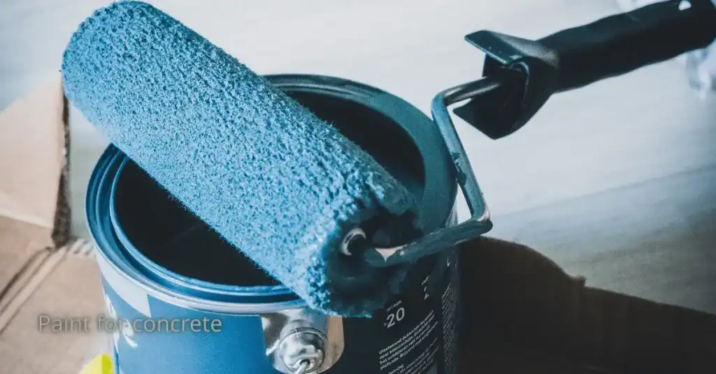 Blue paint roller resting on an open paint can