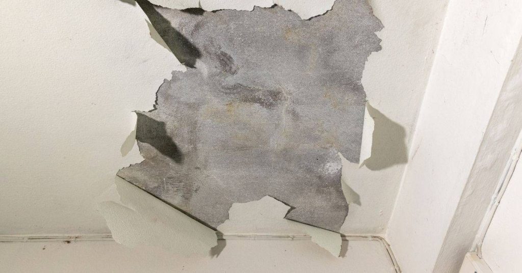 Concrete ceiling with peeling white paint