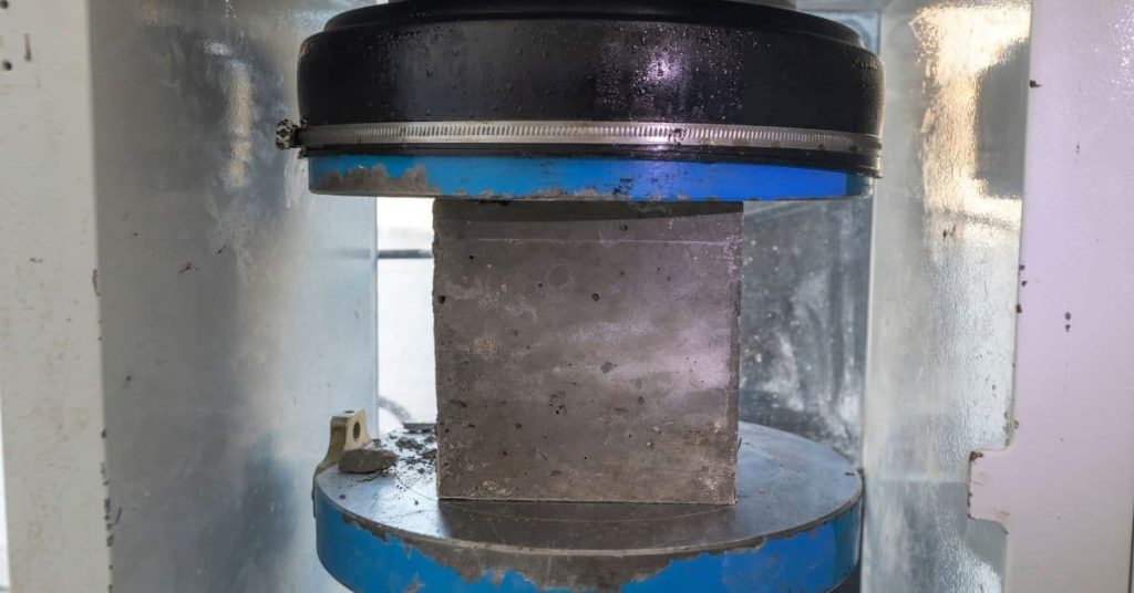 concrete compression test cube inside testing machine