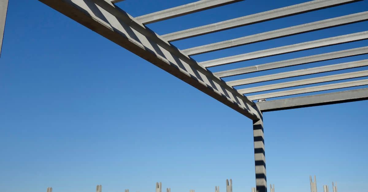 Concrete beam and skeleton frame under clear blue sky