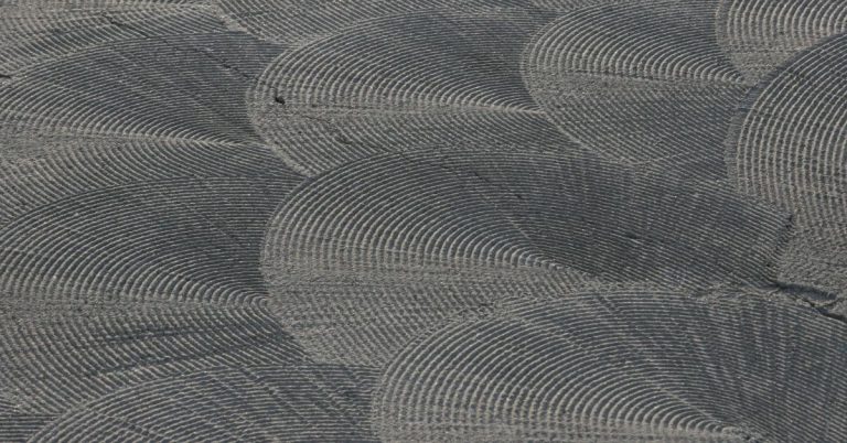Close-up of textured concrete surface with semicircular pattern