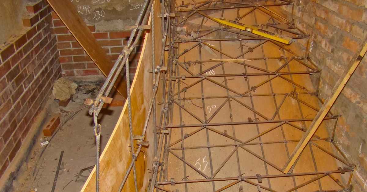 Concrete formwork with exposed rebar and wooden supports