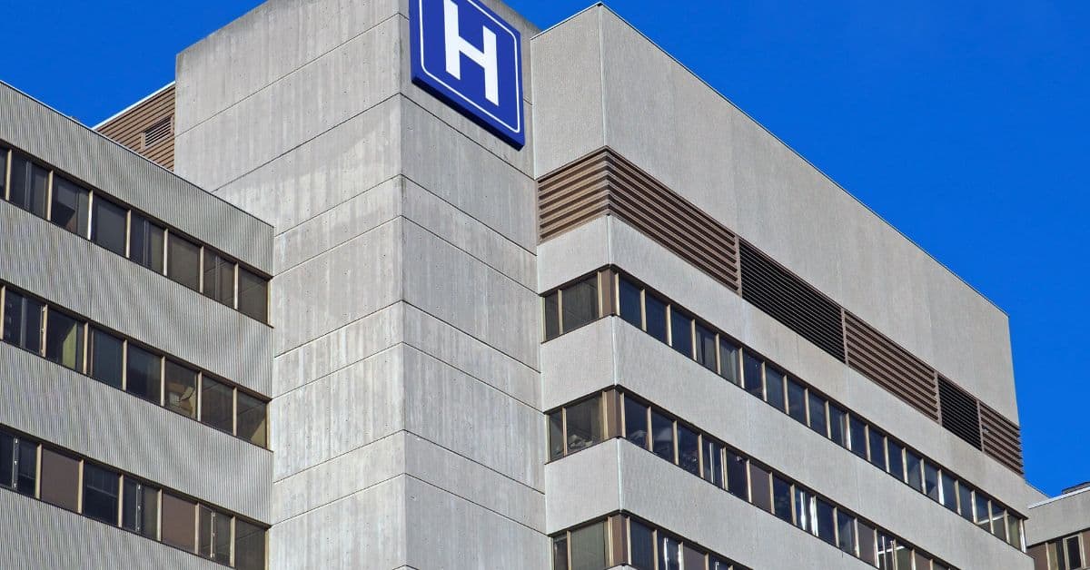 multi story concrete building facade with hospital sign