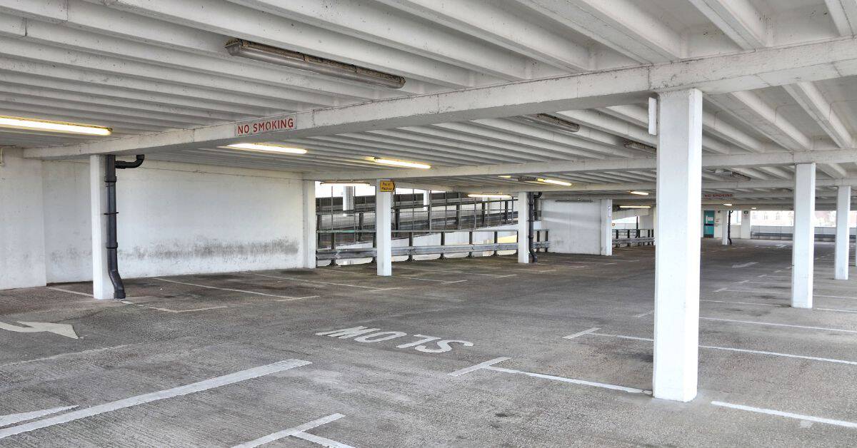 Empty concrete parking garage interior with support columns