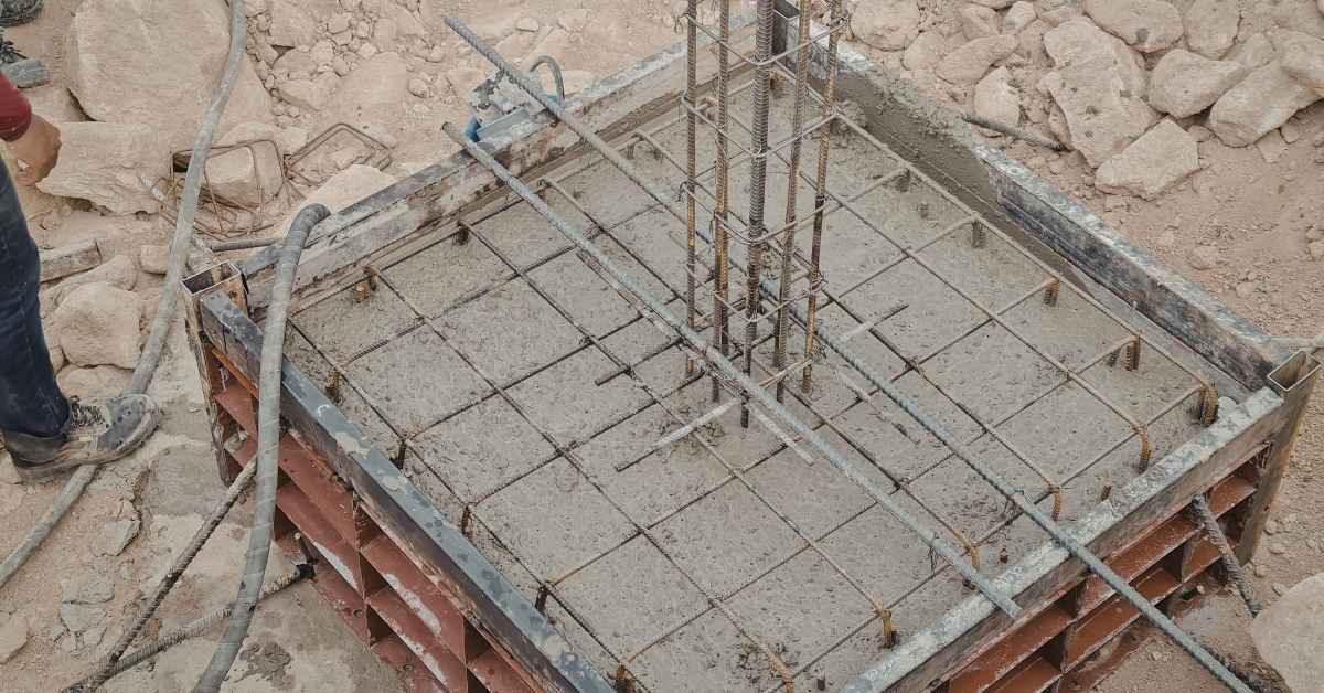 Concrete being poured into rebar reinforced square form