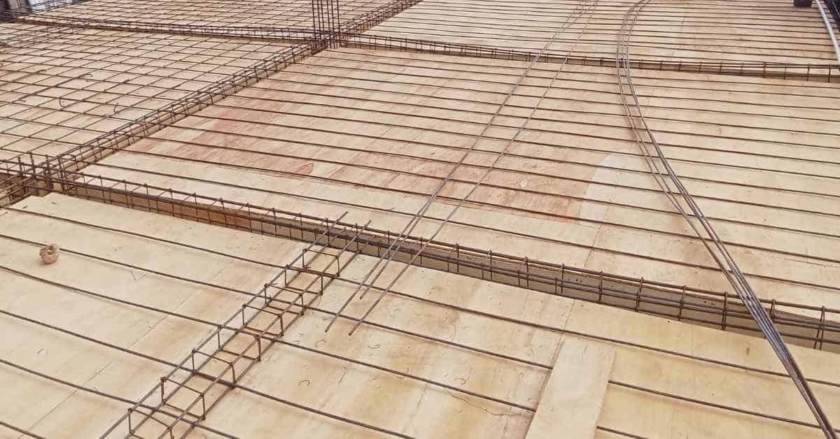Steel rebar grid placed over wooden formwork for concrete slab