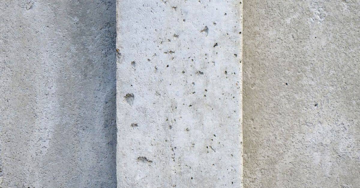close up of concrete wall surface with small holes and imperfections