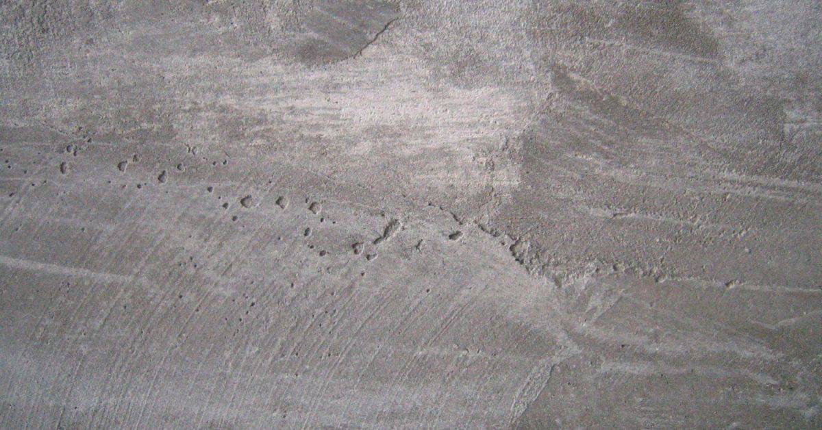 Close-up of concrete surface with pitting and rough texture