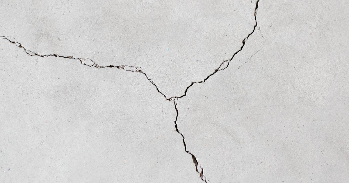 Close-up of intersecting cracks on concrete surface