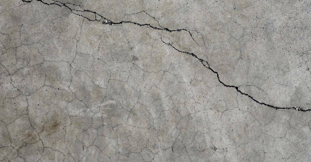 Cracked concrete surface with visible spiderweb cracks