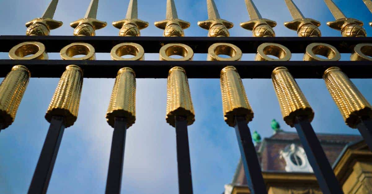 black metal fence with gold decorative spikes and round ornaments