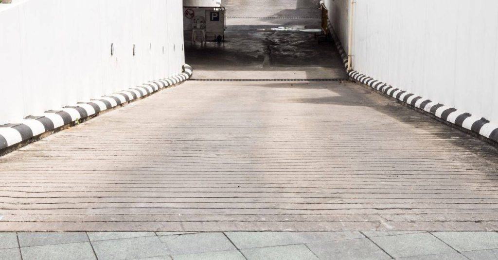 Concrete driveway ramp with grooved textured surface