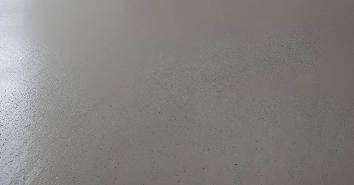 Closeup of smooth gray concrete surface with small pores