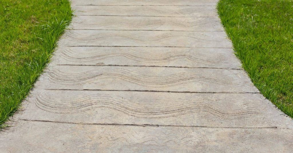 Concrete pathway with wave texture and green grass sides