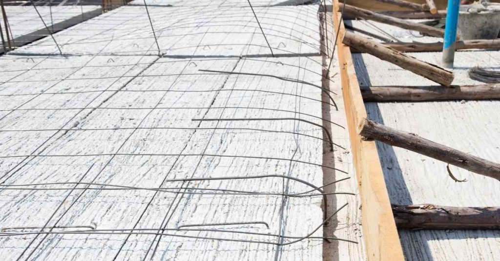 Concrete slab form with wire rebar grid and bent dowels