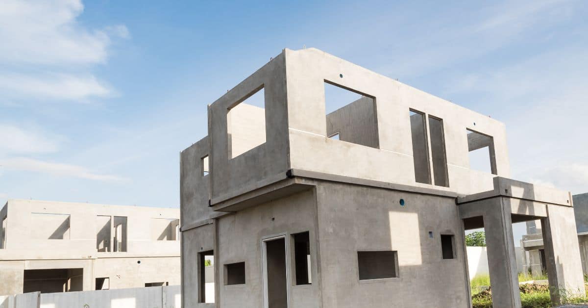 Unfinished concrete building structure with open window frames