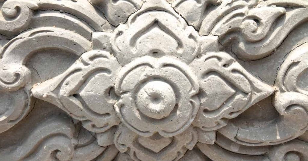 Decorative plaster floral relief with visible cracks