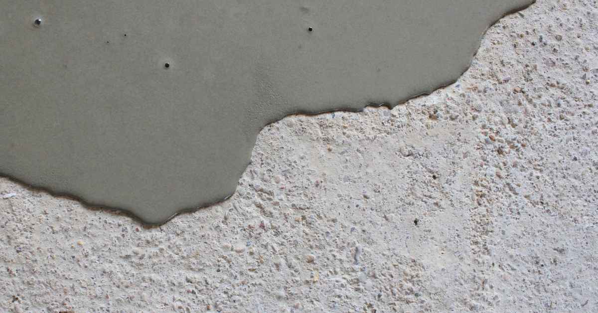 fresh concrete poured onto rough old concrete surface