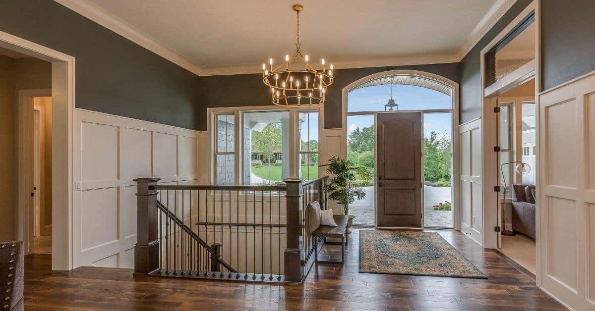 Entryway with polished hardwood floor and open front door