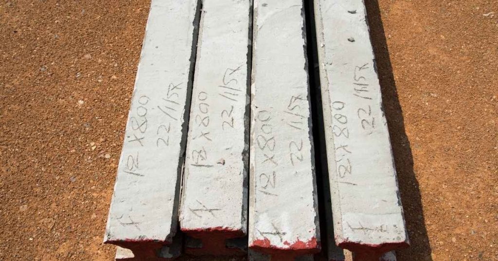 Four concrete test slabs with handwritten measurements on top