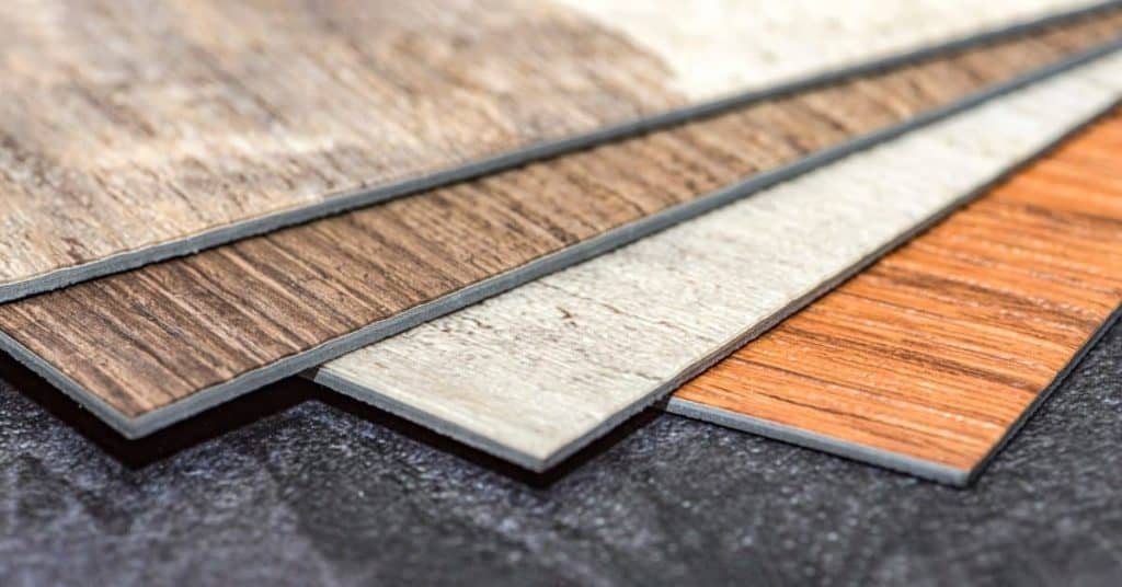Four vinyl flooring planks with different wood grain finishes