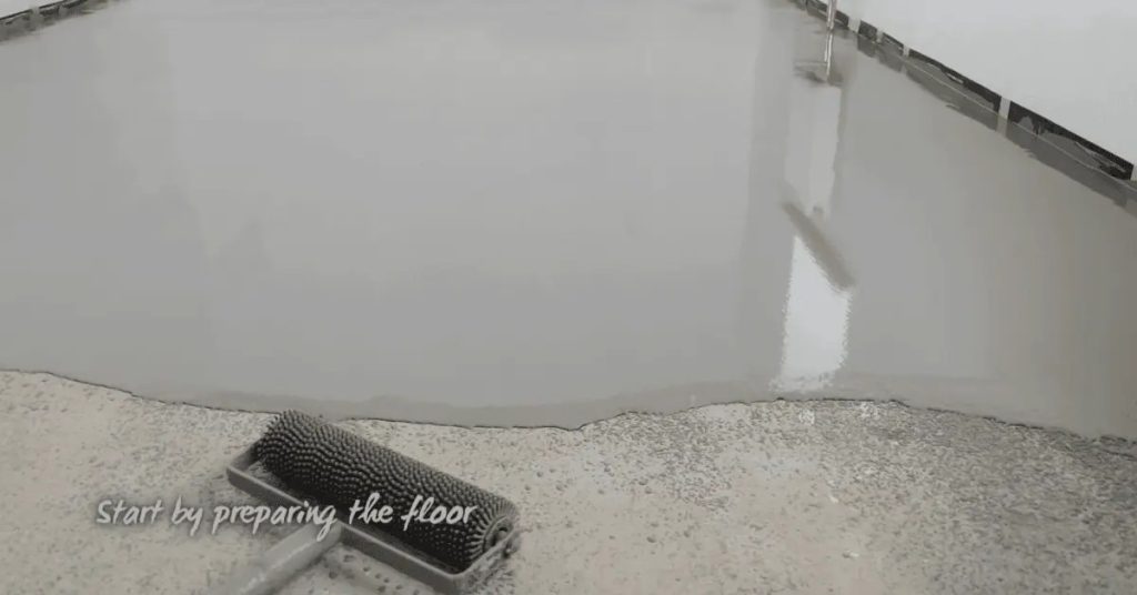 Fresh epoxy coating being rolled onto garage floor