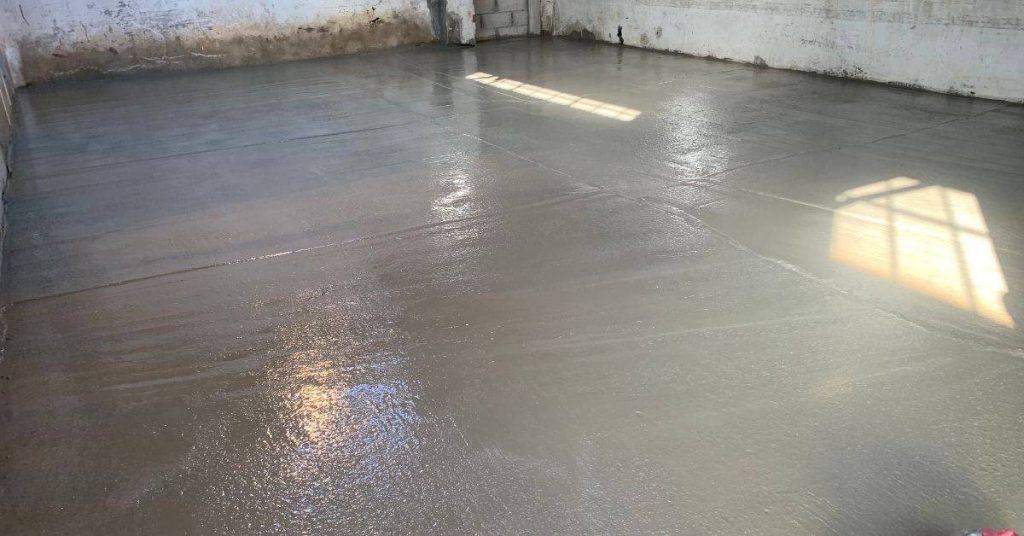 Freshly poured concrete floor inside a building