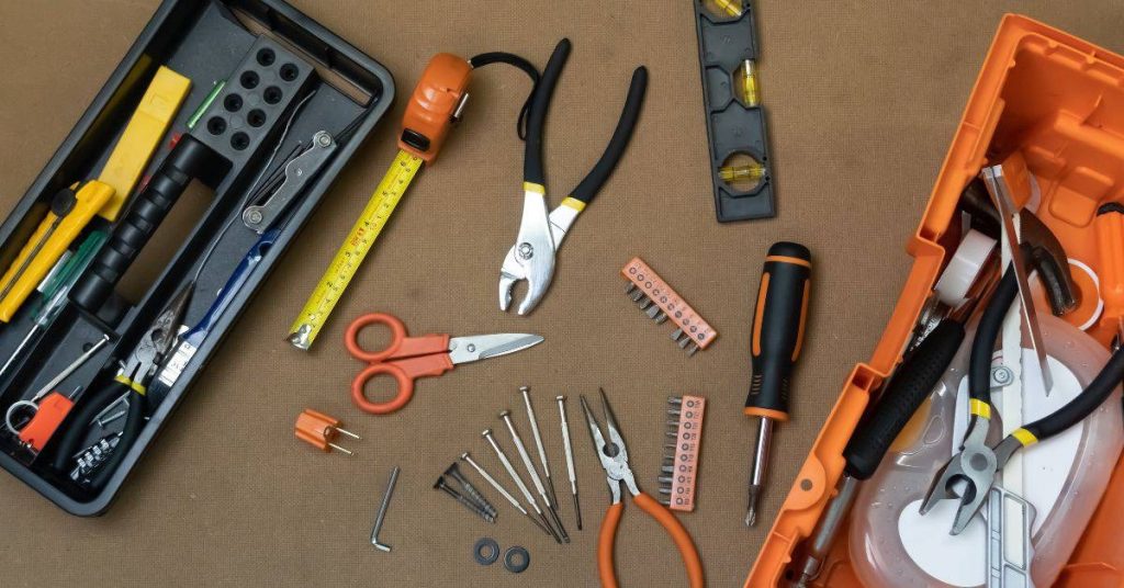 Hand tools including scissors pliers screwdrivers tape measure and level