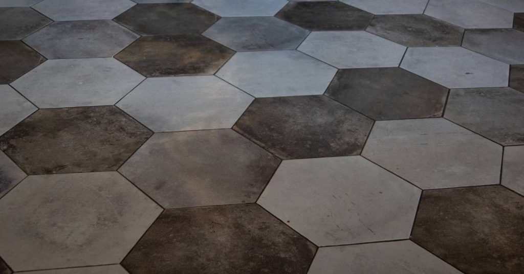 hexagon-shaped floor tiles in varying shades of gray and brown