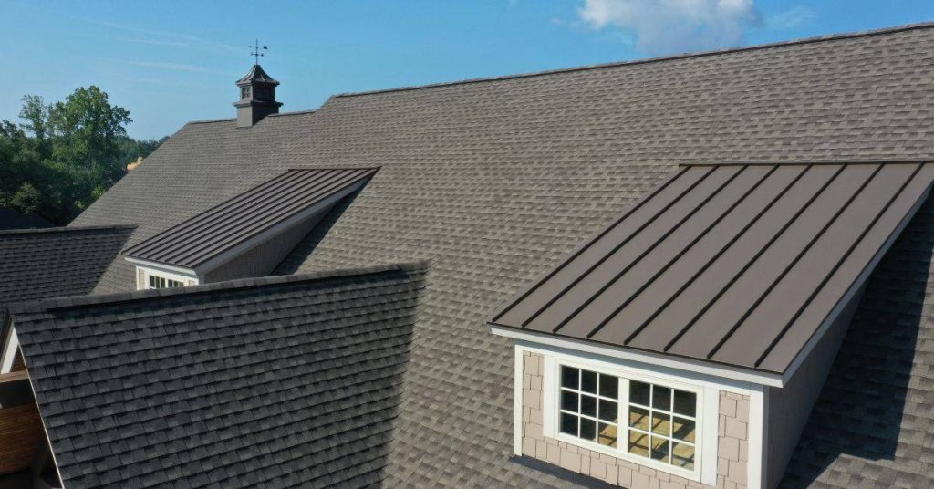 house roof with asphalt shingles and metal roofing panels
