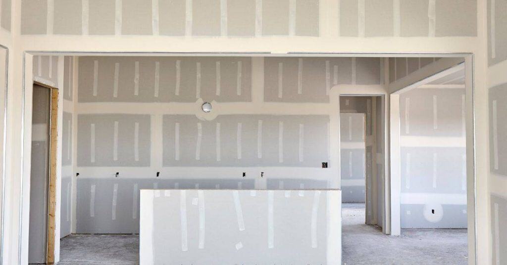 Interior room with unfinished drywall and taped seams