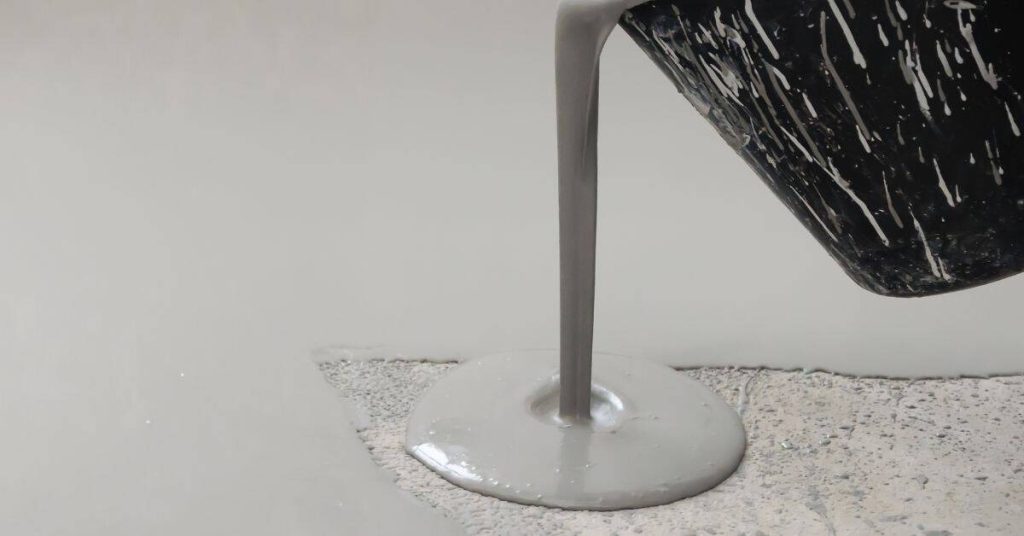 Liquid concrete poured from container onto surface