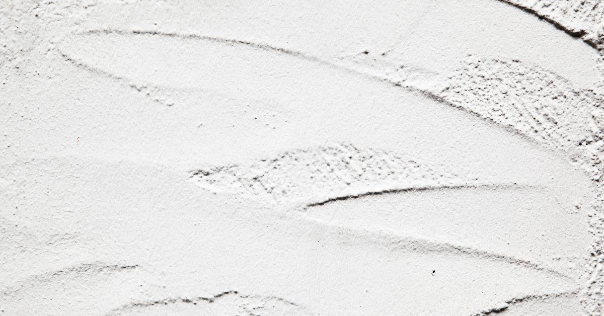 Closeup view of textured white stucco surface