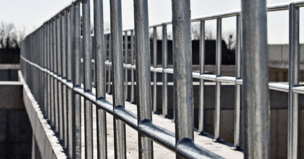 Close-up of galvanized metal railing with vertical and horizontal bars