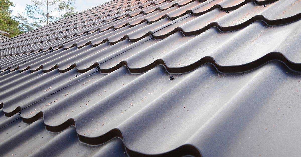 Closeup of dark metal roofing panels with screws