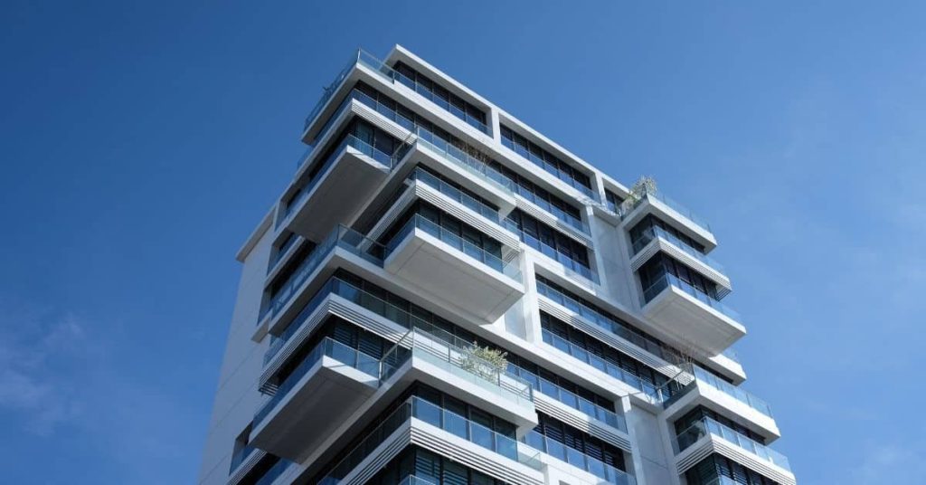 modern multi-story apartment building with concrete surfaces and balconies