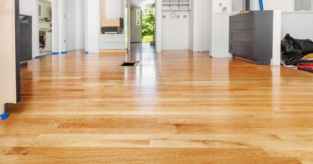 Newly installed light wood hardwood floor in room under renovation