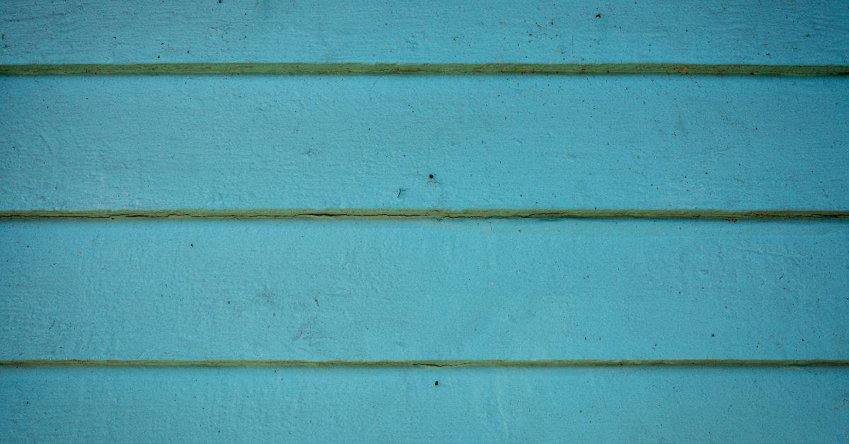 Blue painted wood siding with horizontal panels