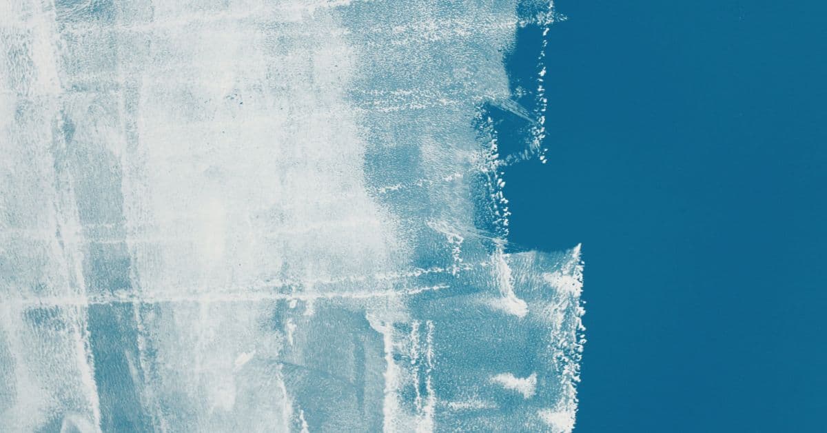 Wall with partially applied blue paint showing uneven coverage