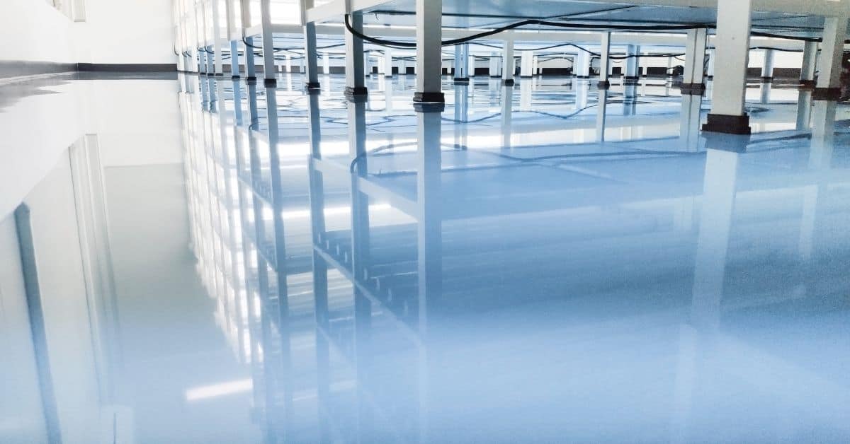Shiny reflective blue epoxy floor with metal racks
