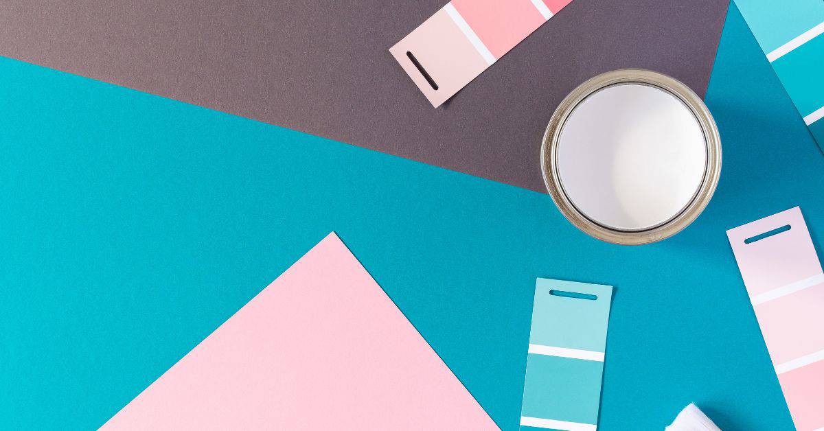 Open can of white paint and various color swatch cards