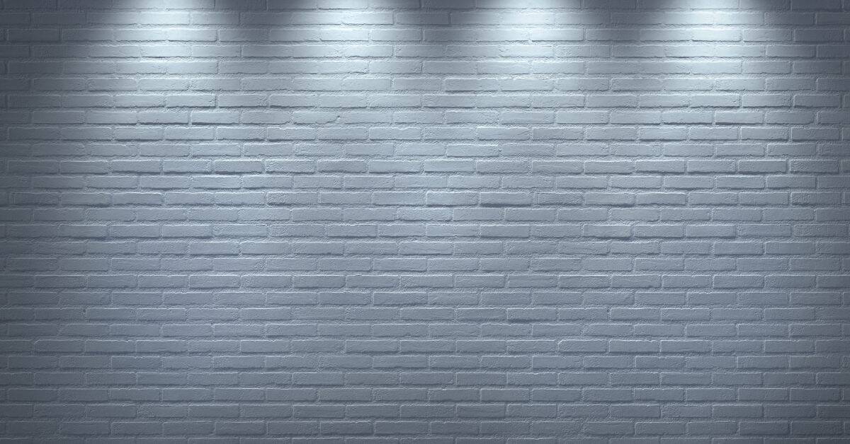 Gray painted brick wall under spotlights