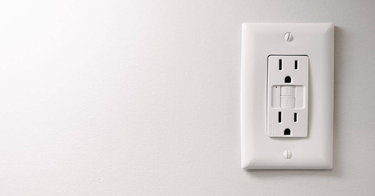 White electrical outlet on painted white wall