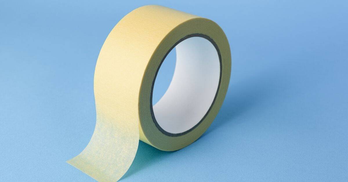 roll of beige masking tape on blue surface