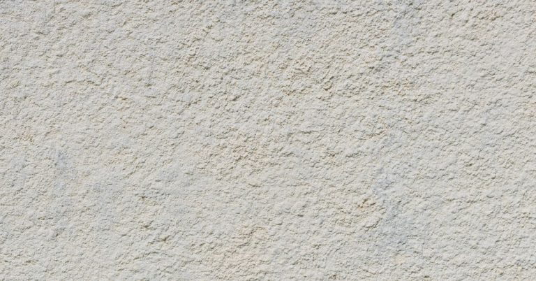 Close-up of rough textured stucco wall surface